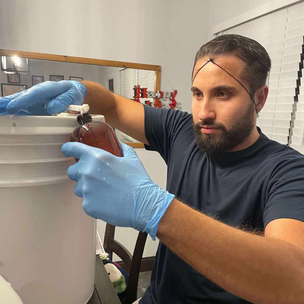 Raw Organic Cosmetics team carefully handcrafting organic body wash with a pump, ensuring high-quality ingredients and attention to detail in every product.