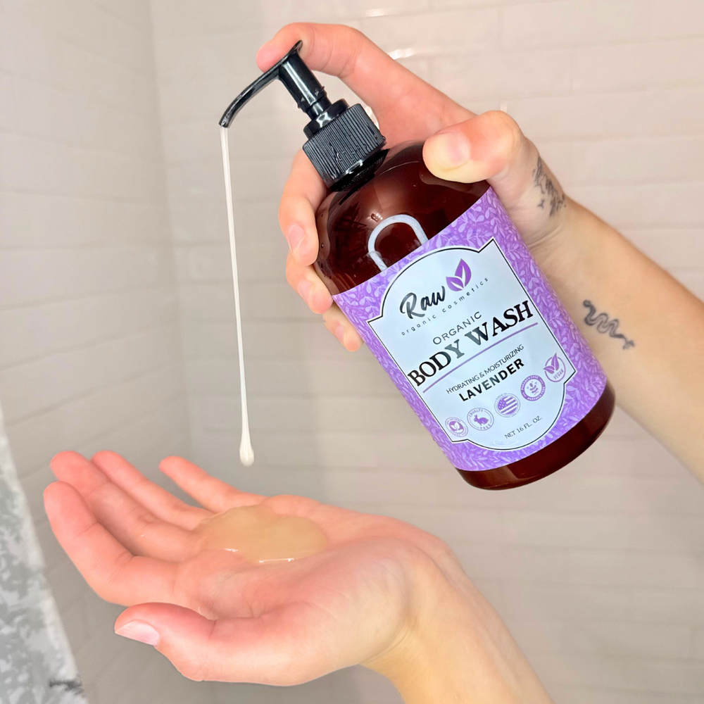 A woman pouring organic lavender body wash onto her hands. This natural, hydrating, and moisturizing body wash is perfect for women, featuring a pump bottle for easy use. Gentle on sensitive skin, made with all-natural ingredients like shea butter and coconut, and offering a soothing lavender scent.