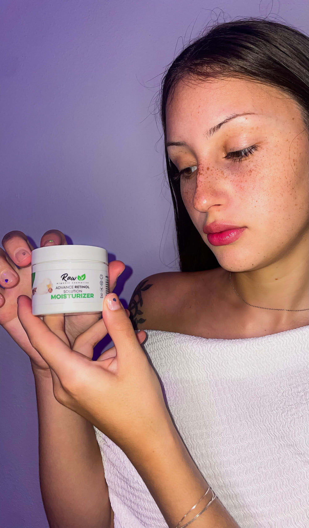 Young woman applying Raw Organic Cosmetics organic retinol face cream, highlighting its rejuvenating and hydrating benefits for smoother, healthier skin